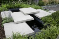'Shades of Grey' at BBC Gardener's World Live 2021 - paved path over pond in urban contemporary garden 
