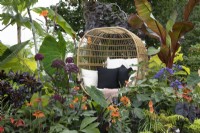 'Garden Envy' at BBC Gardener's World Live 2021 - mixed exotic planting with egg seat