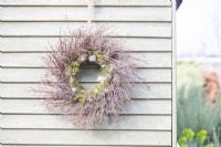 Twig wreath hanging on a wooden wall