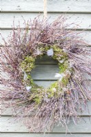 Twig wreath hanging on a wooden wall