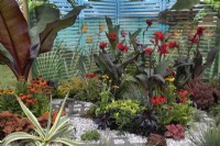 'In Memento' at BBC Gardener's World Live 2021 - tropical leaves and flowers in hot colours