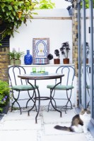 Mediterranean corner with table and chairs and small Moroccan tile fountain. 