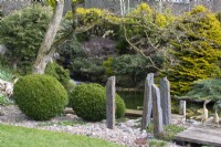 Slate pillars bordering the pond at John's Garden at Ashwood Nurseries - Kingswinford - Spring