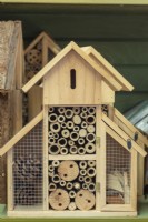 Shelf with wooden insect habitat houses for sale