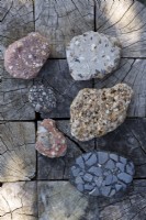 Textured pebbles on wooden background