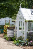Greenhouse with chain water collector in a galvanised container.  RHS No Dig Allotment Demonstration Garden in Association with Charles Dowding and Stephanie Hafferty
