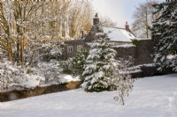 View to The Gardener's Cottage through snow covered trees - Ston Easton Park, Somerset