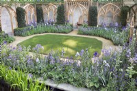 Wooden cloistered garden with oval lawn, gravel paths and blue, mauve and white colour themed borders. 
Planting includes: Bearded iris, Brunnera, Nepeta catmint, Borago officinalis borage, lavender and Campanulas.

Stonemarket Boat Race Anniversary Garden

RHS Chelsea Flower Show 

Designer: Bunny Guiness