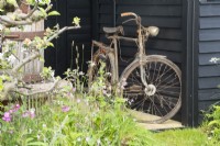 Rusty bike in 'The Longcroft Press' Show Garden at RHS Malvern Spring Festival 2022 - Designer Laura Ashton-Philips - Bronze Medal winner