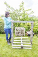 Woman lifting the outside edge of the pallet away from the middle