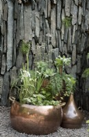 Reclaimed copper still planters with aquatic and native Scottish planting in slate setting