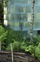 Giant block of ice in Siberian woodland garden with 