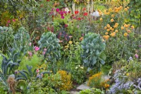 Mixed borders of perennials, annuals, vegetables and herbs: Brassica 'Nero di Toscana', fennel, Brussel sprouts, dahlia, Calendula officinalis, Tagetes tenuifolia, Aster, Zinnia elegans, Cosmos and curly kale.