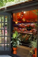 View of the bar area in the Planet
 Studio with by the door, houseplant Dieffenbachia 'Tiki' in an orange pot - Designer: James Whiting - Sponsor: Malvern Garden Buildings.
