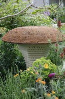 View of the mushroom- shaped bee house in the BBC Studios Our Green Planet and RHS Bee Garden with holes of various sizes to accomodate different bees- Designer: Joe Swift