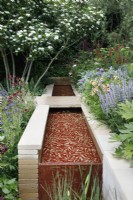 In the Morris  and  Co. Garden, a water channel built with Yorkshire stone is inlaid with a metal screen,  laser-cut with Morris's 'Willow Boughs 'pattern - Designer: Ruth Willmott - Sponsor: Morris  and  Co.