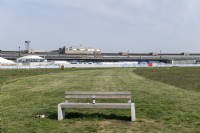 Berlin Germany 
Now redundant Berlin Tempelhof Airport. Now a recreational space known as Tempelhofer Feld . 
Benches in front of the former apron and terminal buildings. 
With litter. 