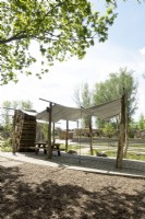 Shelter made by tree trunks and recycled materials.