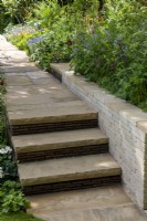 Yorkstone steps with handmade clay tile risers, next to a clay paver raised bed - Morris  and  Co, RHS Chelsea Flower Show 2022 - Gold Medal