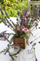 Table centrepiece of timber box filled with lavender, roses and poppy seedheads - Lavender summer party story