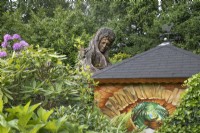 Blodeuwedd wooden sculpture at Hamilton House garden in May 