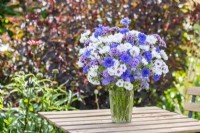 Bouquet containing Centaurea 'Double Blue', Centaurea 'Ball White' - Cornflowers, Phlox drummondii 'Tapestry', Ageratum 'Blue Mink' and Verbena bonariensis