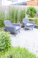 Enclosed seating area on modern grey stone slab patio