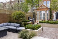 Suburban garden in spring - seating area in contemporary suburban garden, with views towards house