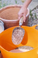 Woman putting gravel in the trug