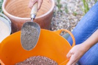 Woman putting soil in the trug
