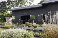 Black processing shed at a flower farm in July