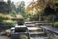 Stepped terraces with water feature in a country garden in November