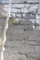 Layered slate backing for waterfall feature