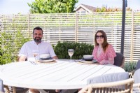 Garden owners sitting at outdoor dining table