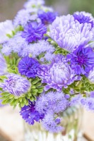 Small bouquet containing Callistephus 'Light Blue', Centaurea 'Double Blue' and Ageratum 'Blue Mink'