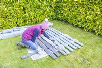 Woman painting wooden planks