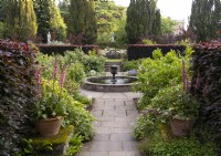 A view of the urn shaped fountain and circular pond in the rose garden at Newby Hall Gardens.