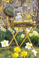 Yellow themed arrangement with daffodils and wreath of willow twigs.