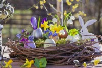 Easter arrangement with grapevine wreath nest, coloured egg shells planted with spring flowers.