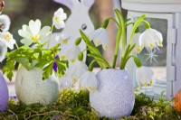 Easter arrangement with egg shell and snowflakes.