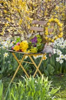 Chair with wreath made of willow twigs and daffodils.