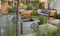 Decorative water butts as water feature in #knollingwithdaisies garden at RHS Hampton Court Palace Garden Festival 2022