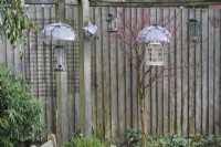 Squirrel proof bird feeders with plastic baffle