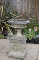 Stone bird bath in a garden setting 
