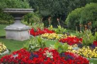 Bedding plants by a large stone urn 