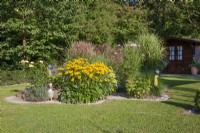 Garden design with perennials, ornamental grassess, summer July