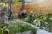 Suburban garden in summer with contemporary wooden fence