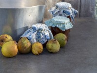 Harvested pears used to make pear and ginger jam.  Preserving pan with left over fruit and finished jams