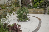 Circular bed with pebble and granite sett detail in the Metamorphosis garden at BBC Gardener's World Live 2022
