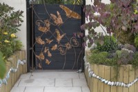Decorative metal gate panel in the Metamorphosis garden at BBC Gardener's World Live 2022
